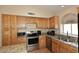 Well-lit kitchen featuring stainless steel appliances and granite countertops offering both style and functionality at 1212 W Vera Ln, Tempe, AZ 85284