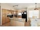 Spacious kitchen featuring a central island, light wood cabinets, and stainless steel appliances, perfect for cooking at 1212 W Vera Ln, Tempe, AZ 85284