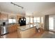 Kitchen featuring a large island, granite countertops, natural wood cabinets, and stainless steel appliances at 1212 W Vera Ln, Tempe, AZ 85284