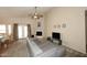 Spacious living area showcasing a vaulted ceiling, fireplace, and natural light at 1212 W Vera Ln, Tempe, AZ 85284