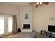 Bright living room featuring a corner fireplace and access to the patio at 1212 W Vera Ln, Tempe, AZ 85284