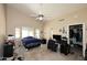 Bedroom with a ceiling fan, large window, and closet offers generous natural light at 1212 W Vera Ln, Tempe, AZ 85284