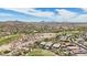 A high-angle aerial view features desert homes, a golf course, native desert landscape, and distant mountains at 12381 S 182Nd Dr, Goodyear, AZ 85338
