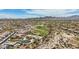 Broad aerial shot of houses, a golf course, sparse vegetation, and rolling mountains in a large Primary-planned community at 12381 S 182Nd Dr, Goodyear, AZ 85338