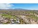 An expansive residential community nestled among desert vegetation and a golf course with a scenic mountain range in the background at 12381 S 182Nd Dr, Goodyear, AZ 85338