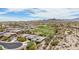 Expansive aerial view of a residential community showcasing desert landscaping, golf course, and mountain views at 12381 S 182Nd Dr, Goodyear, AZ 85338