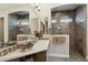 Bright primary bathroom with double sinks, tile flooring, and glass shower; perfect for starting and ending the day at 12381 S 182Nd Dr, Goodyear, AZ 85338