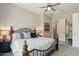 Bedroom featuring carpet, a ceiling fan, and a view to the ensuite bathroom at 12381 S 182Nd Dr, Goodyear, AZ 85338