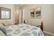 Bedroom with ensuite bathroom features neutral colors, carpet, and comfortable bed with sand-dollar themed comforter at 12381 S 182Nd Dr, Goodyear, AZ 85338