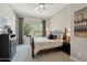 Bedroom featuring windows for natural light, carpet, and a ceiling fan at 12381 S 182Nd Dr, Goodyear, AZ 85338