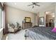 Bedroom with cozy seating area, natural light, and neutral color scheme is ideal for relaxing and restful sleep at 12381 S 182Nd Dr, Goodyear, AZ 85338