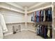 Spacious walk-in closet with multiple shelves and rods, providing ample storage for all your wardrobe needs at 12381 S 182Nd Dr, Goodyear, AZ 85338