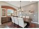 Charming dining room features a stylish chandelier, a bar, and seating for six at 12381 S 182Nd Dr, Goodyear, AZ 85338