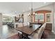 Open-concept dining room features a long wood table, comfortable seating, and access to the kitchen at 12381 S 182Nd Dr, Goodyear, AZ 85338