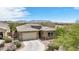 Beautiful single-story home featuring a neutral color palette, brick accents, a two-car garage, and desert landscaping at 12381 S 182Nd Dr, Goodyear, AZ 85338
