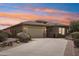 Inviting single-story home features a spacious driveway and a well-maintained desert landscape at 12381 S 182Nd Dr, Goodyear, AZ 85338