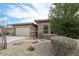 Charming single-story home features a spacious driveway, well maintained desert landscaping, and stone accents at 12381 S 182Nd Dr, Goodyear, AZ 85338