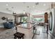 Open kitchen featuring a large island, granite countertops, and stainless steel appliances that connects to the living room at 12381 S 182Nd Dr, Goodyear, AZ 85338