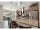 Spacious kitchen features a large island, bar-style seating, and stainless steel appliances at 12381 S 182Nd Dr, Goodyear, AZ 85338
