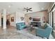 Inviting living room features comfortable sofas, tile floors, and large windows for natural light at 12381 S 182Nd Dr, Goodyear, AZ 85338