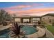 A stunning backyard oasis showcasing a private pool, spa, built-in BBQ, and desert landscaping at 12381 S 182Nd Dr, Goodyear, AZ 85338