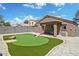 Backyard featuring a personal putting green and low maintenance landscaping with privacy fence at 12621 W Willow Ave, El Mirage, AZ 85335