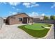 Beautiful backyard features a personal putting green, perfect for outdoor recreation and relaxation at 12621 W Willow Ave, El Mirage, AZ 85335