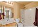A bathroom offers a shower over tub and a wood vanity with a mirror at 12621 W Willow Ave, El Mirage, AZ 85335
