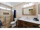 Updated bathroom featuring a step-in shower with pebble floor and wood-look vanity at 12621 W Willow Ave, El Mirage, AZ 85335