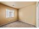 Neutral bedroom featuring carpet, a large window, and a closet at 12621 W Willow Ave, El Mirage, AZ 85335