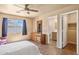 The main bedroom features wood floors, a dresser, an ensuite and a window at 12621 W Willow Ave, El Mirage, AZ 85335