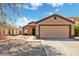 Inviting single-story home featuring a two-car garage and desert landscaping at 12621 W Willow Ave, El Mirage, AZ 85335
