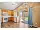Cozy kitchen features wood cabinets, a white appliance package, and access to the backyard at 12621 W Willow Ave, El Mirage, AZ 85335