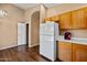 The kitchen offers wood floors, light cabinets, stainless steel appliances, and an arched doorway at 12621 W Willow Ave, El Mirage, AZ 85335