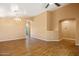 Open living area with chandelier, tile floors, and archways, perfect for entertaining at 12621 W Willow Ave, El Mirage, AZ 85335
