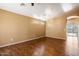 Spacious living room with elegant chandelier and beautiful wood-look tile flooring at 12621 W Willow Ave, El Mirage, AZ 85335