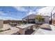 Outdoor kitchen and dining area in backyard with pavers, and grill at 12708 W Corona Ave, Avondale, AZ 85323