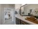 Bathroom with a large mirror, white quartz counter and dark wood cabinets at 12708 W Corona Ave, Avondale, AZ 85323