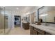 Elegant bathroom equipped with double vanities, a glass shower, and access to a walk-in closet for optimal convenience at 12708 W Corona Ave, Avondale, AZ 85323