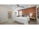 Stylish bedroom featuring an accent wall, ceiling fan, and neutral-toned carpet at 12708 W Corona Ave, Avondale, AZ 85323