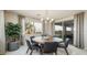 Bright dining area with large windows, a modern chandelier, and comfortable seating at 12708 W Corona Ave, Avondale, AZ 85323