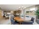 Bright dining area with a modern chandelier, complemented by a kitchen featuring stainless steel appliances and ample counter space at 12708 W Corona Ave, Avondale, AZ 85323