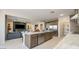 Open kitchen featuring stainless steel appliances, island with bar seating, and seamless living area access at 12708 W Corona Ave, Avondale, AZ 85323