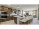 Modern kitchen with stainless steel appliances, a spacious island, and stylish bar stools at 12708 W Corona Ave, Avondale, AZ 85323