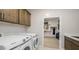 Laundry room with sink, cabinets, washer, and dryer, plus a walk in closet at 12708 W Corona Ave, Avondale, AZ 85323