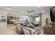 Open concept living room with modern furnishings, ceiling fan, and views into the kitchen at 12708 W Corona Ave, Avondale, AZ 85323