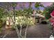 Rear exterior view of a charming home with desert landscaping and covered patio at dusk at 12972 W Kokopelli Dr, Peoria, AZ 85383