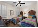 Inviting bedroom showcasing two twin beds with decorative headboards and colorful bedding at 12972 W Kokopelli Dr, Peoria, AZ 85383