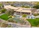 Aerial view of the clubhouse with outdoor dining, pond, and manicured landscaping at 12972 W Kokopelli Dr, Peoria, AZ 85383