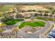 Aerial view of the clubhouse featuring manicured lawns, landscaping, and ample parking at 12972 W Kokopelli Dr, Peoria, AZ 85383